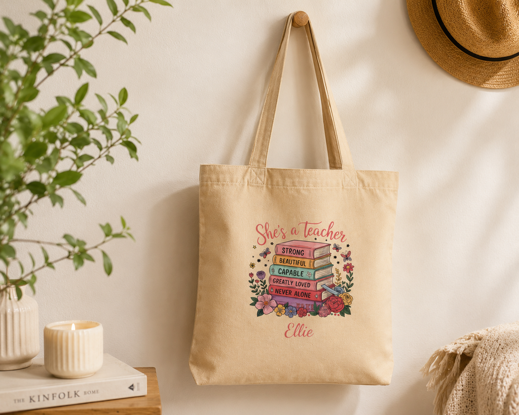 Close-up of book stack illustration and personalized name on teacher tote
